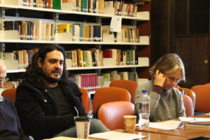 Dos participantes del encuentro conversando en la biblioteca del CECTS